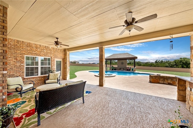 view of patio featuring ceiling fan, a gazebo, outdoor lounge area, and a pool with hot tub