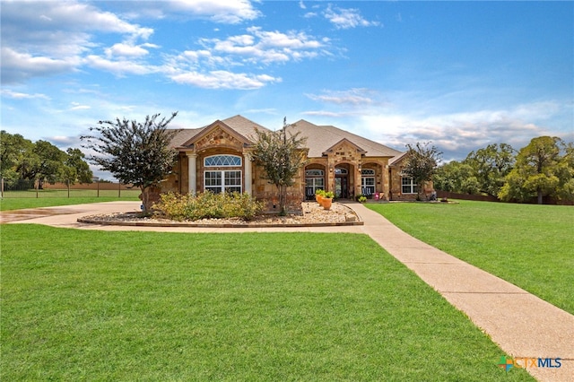 ranch-style home featuring a front yard