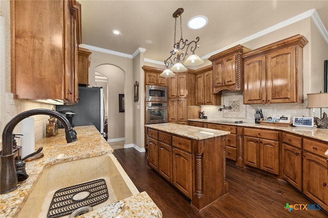 kitchen with appliances with stainless steel finishes, dark wood-type flooring, and light stone countertops