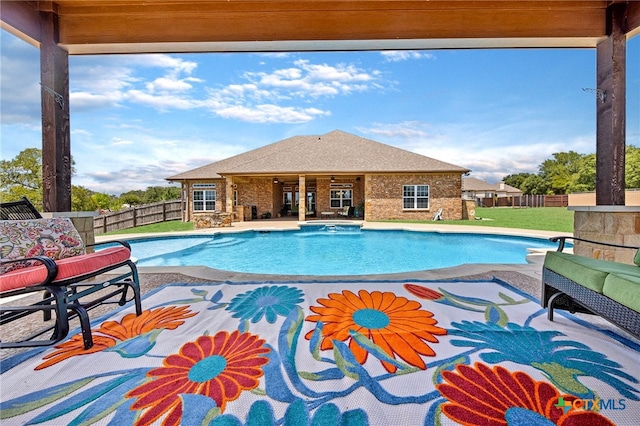 view of pool with a patio and a yard