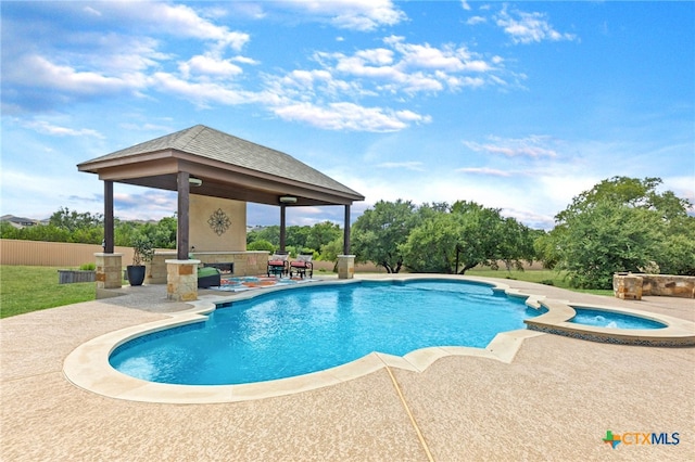 view of pool with an in ground hot tub, a gazebo, and a patio area