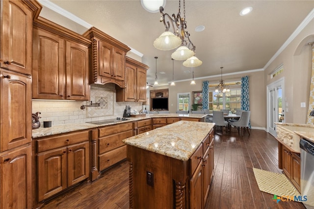 kitchen featuring ornamental molding, black electric stovetop, decorative light fixtures, dark wood-type flooring, and kitchen peninsula