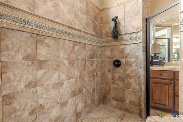 bathroom featuring vanity and a tile shower