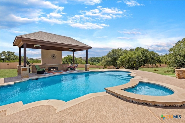 view of pool with a patio area, an in ground hot tub, and a gazebo