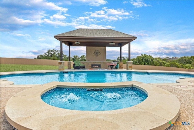 view of pool featuring a patio, an in ground hot tub, and a gazebo