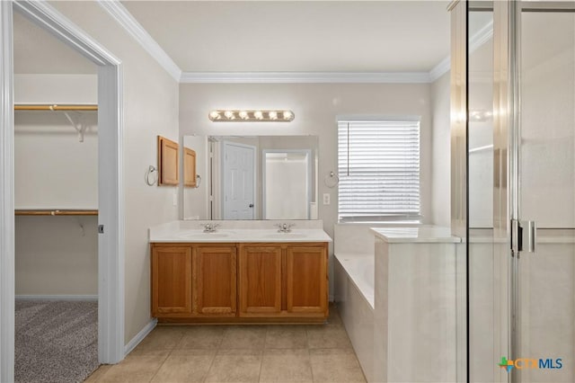 901 Mustang Trl, Harker Heights, TX 76548 - bathroom with crown molding, double vanity, a garden tub, a spacious closet, and an enclosed shower