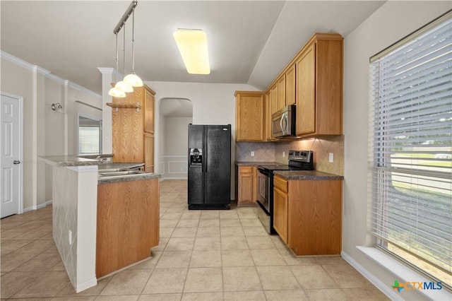 901 Mustang Trl, Harker Heights, TX 76548 - kitchen with stainless steel appliances, decorative backsplash, a peninsula, light tile patterned flooring, and arched walkways