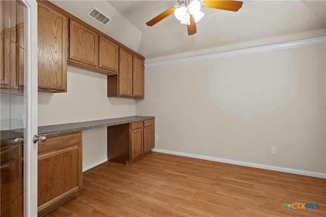 901 Mustang Trl, Harker Heights, TX 76548 - kitchen featuring brown cabinets, light wood-style flooring, a ceiling fan, dark countertops, and lofted ceiling