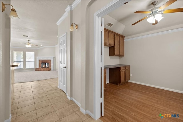 901 Mustang Trl, Harker Heights, TX 76548 - hallway with ornamental molding, light tile patterned floors, and light carpet