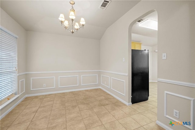 901 Mustang Trl, Harker Heights, TX 76548 - unfurnished dining area with arched walkways, light tile patterned flooring, a chandelier, healthy amount of natural light, and a wainscoted wall