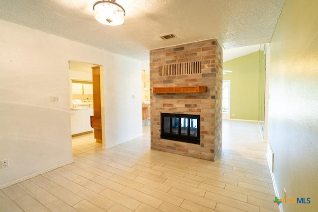 unfurnished living room featuring vaulted ceiling, a fireplace, and a textured ceiling