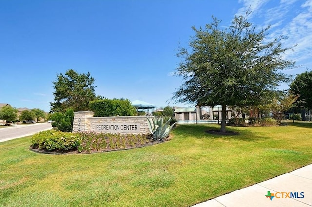 community sign featuring a lawn