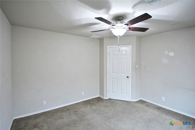 spare room with carpet floors and ceiling fan