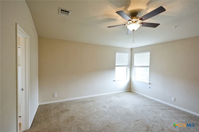 carpeted empty room with a textured ceiling and ceiling fan