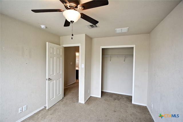 unfurnished bedroom featuring light colored carpet, ceiling fan, and a closet