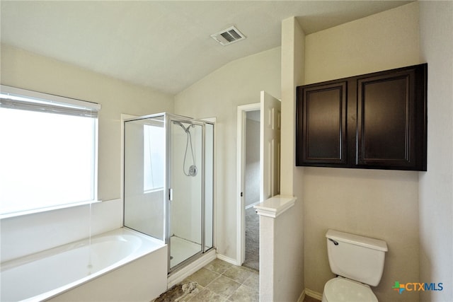 bathroom featuring toilet, lofted ceiling, tile patterned flooring, and separate shower and tub