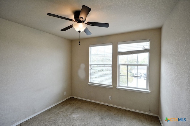 empty room featuring a textured ceiling, carpet flooring, and ceiling fan