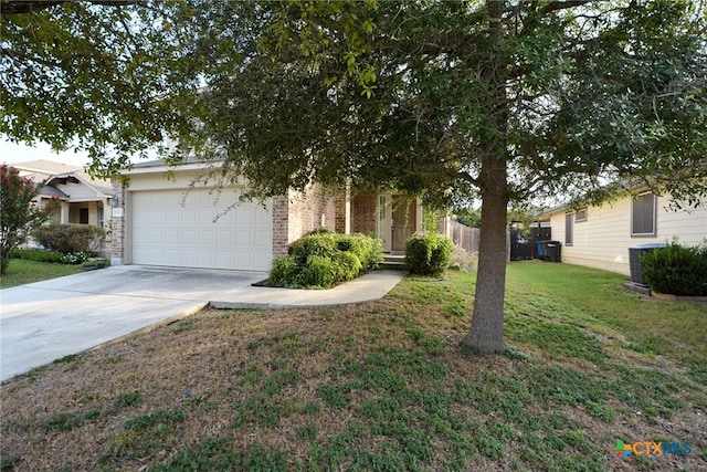 view of property hidden behind natural elements featuring a front lawn, a garage, and cooling unit