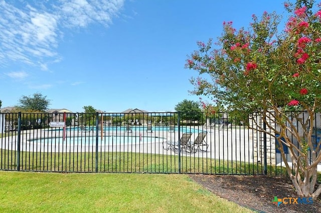 view of pool with a yard