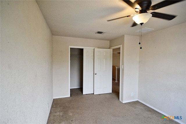 unfurnished bedroom with a closet, carpet, and ceiling fan