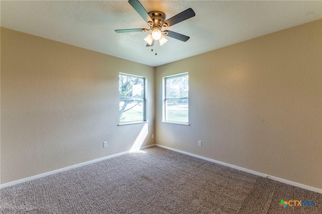 spare room featuring carpet flooring and ceiling fan