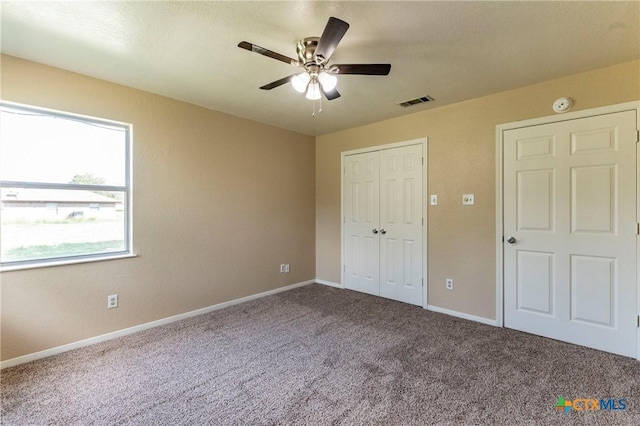 unfurnished bedroom with ceiling fan and carpet floors