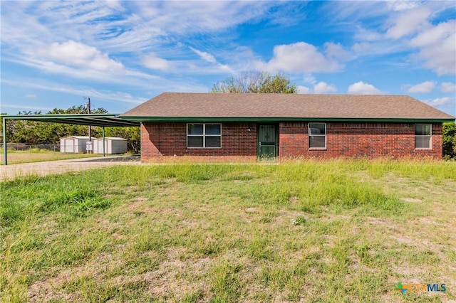 ranch-style home featuring a carport