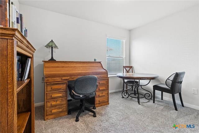 carpeted home office featuring baseboards