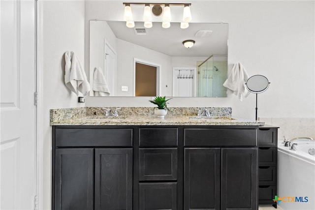 bathroom with a stall shower, a sink, a bath, and double vanity