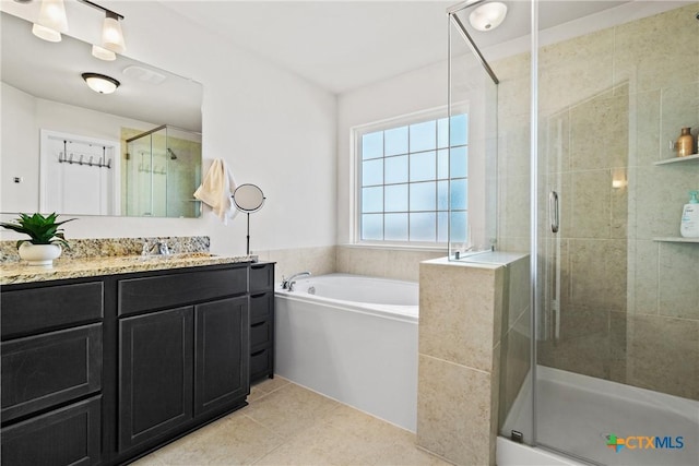 full bathroom featuring a stall shower, tile patterned flooring, vanity, and a bath