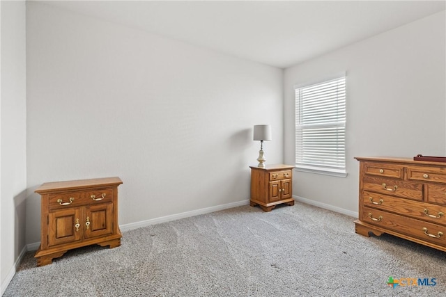 interior space with light carpet and baseboards