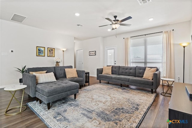 living area featuring recessed lighting, visible vents, and wood finished floors