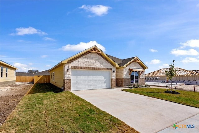 view of front of property featuring a garage and a front yard