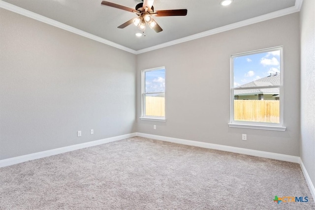 unfurnished room featuring carpet, plenty of natural light, and crown molding