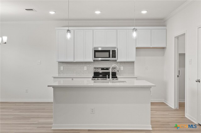 kitchen featuring pendant lighting, sink, a center island with sink, and stainless steel appliances