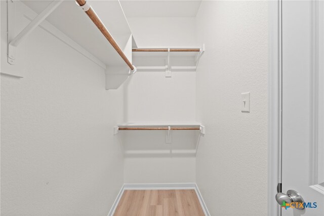 walk in closet featuring light hardwood / wood-style flooring