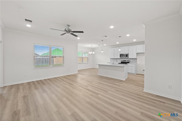 unfurnished living room featuring light wood-type flooring, sink, ceiling fan with notable chandelier, and crown molding