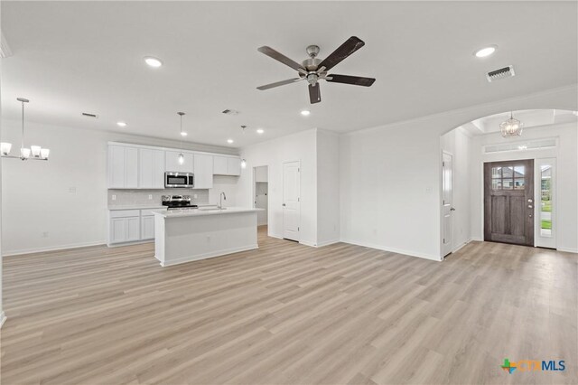 611 Killam Dr, Temple, TX 76502 - unfurnished living room featuring ceiling fan with notable chandelier, sink, light hardwood / wood-style flooring, and ornamental molding