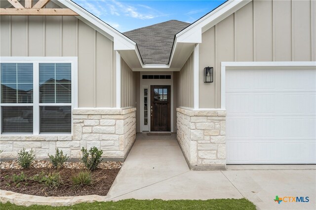 doorway to property with a garage