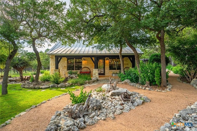 rear view of house featuring a yard