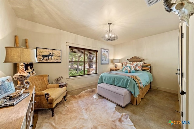 carpeted bedroom featuring an inviting chandelier