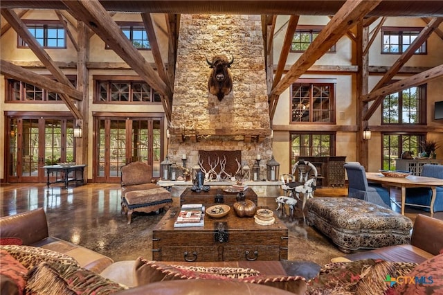 living room with beam ceiling, a fireplace, french doors, and high vaulted ceiling