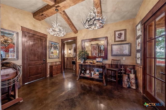 foyer with wooden walls, beamed ceiling, and a notable chandelier