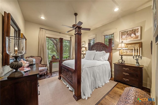 bedroom with ceiling fan and light wood-type flooring