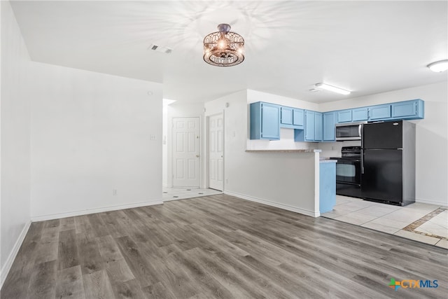 kitchen featuring blue cabinets, black appliances, kitchen peninsula, and light hardwood / wood-style flooring