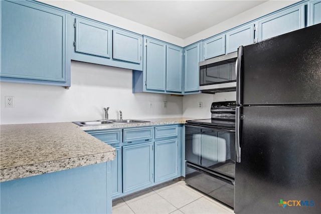 kitchen featuring black appliances, blue cabinetry, sink, and light tile patterned flooring