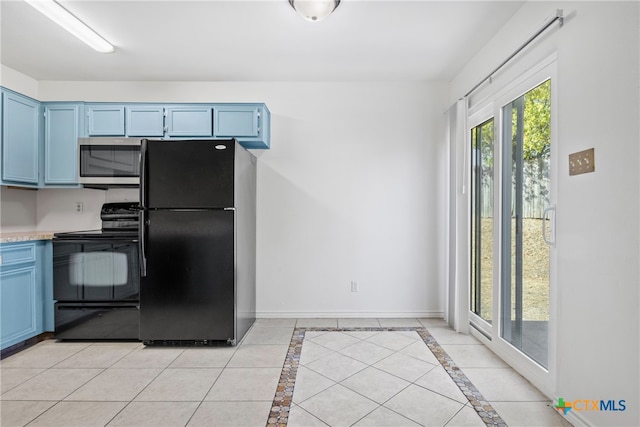 kitchen with black appliances, light tile patterned flooring, and blue cabinets