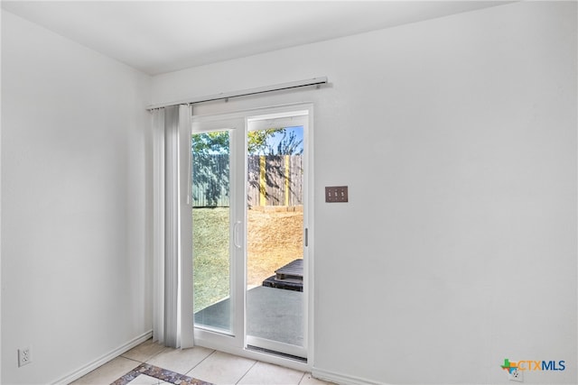 doorway with light tile patterned floors