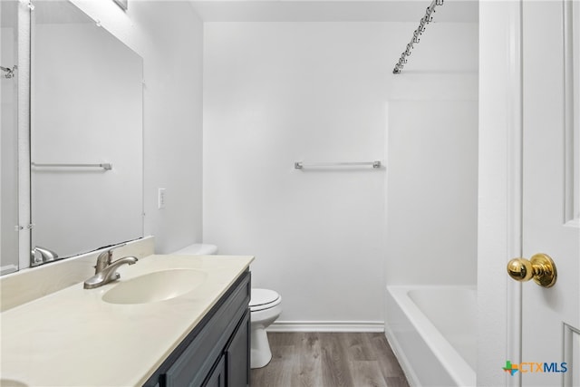 bathroom featuring hardwood / wood-style floors, vanity, and toilet