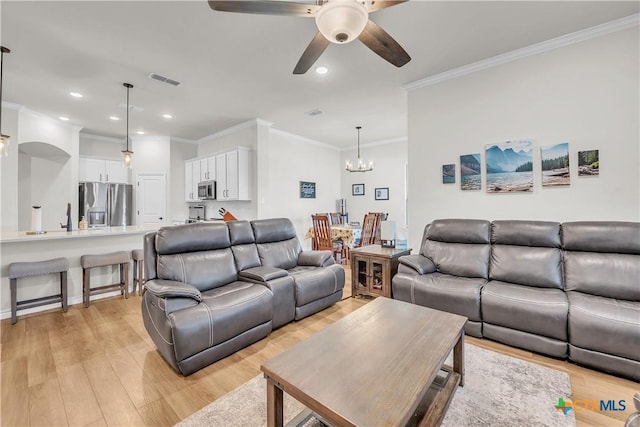 living room featuring crown molding, light hardwood / wood-style floors, and ceiling fan with notable chandelier